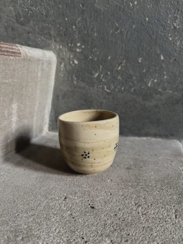The Speckled and Marbled Cappuchino Mug is a wheel thrown ceramic mug out of speckled clay, with a hand painted dot flower and glazed in transparent glaze.